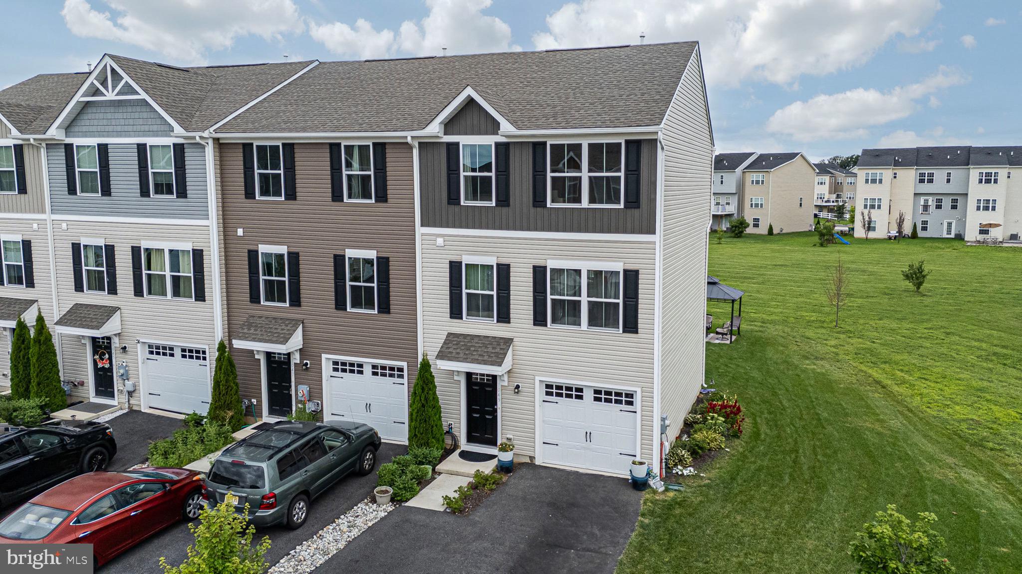 1049 Wickersham Way Middletown, DE 19709 - Photo 3 of 33 a view of a big yard in front of a brick house with a yard