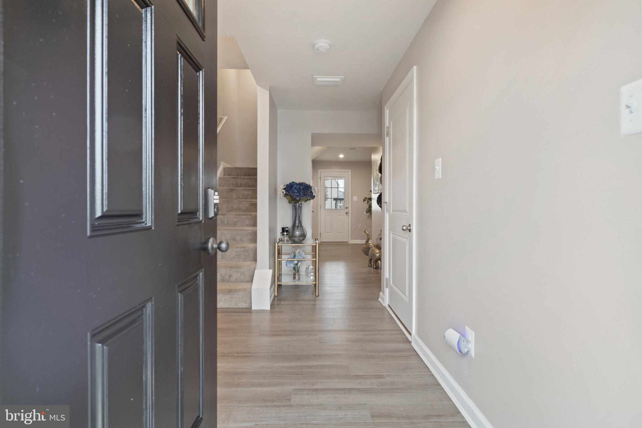 1049 Wickersham Way Middletown, DE 19709 - Photo 5 of 33 a view of a hallway with wooden floor and staircase