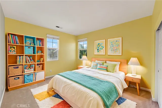 a bedroom with a bed and a book shelf