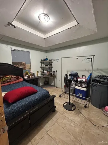a room with gym equipment and a chandelier