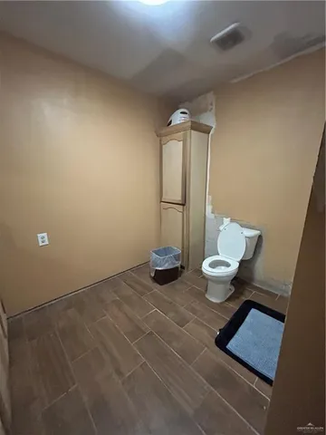 a bathroom with a sink toilet and a mirror