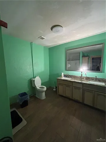 a bathroom with a sink mirror and toilet
