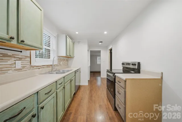 a kitchen with a sink stove and refrigerator