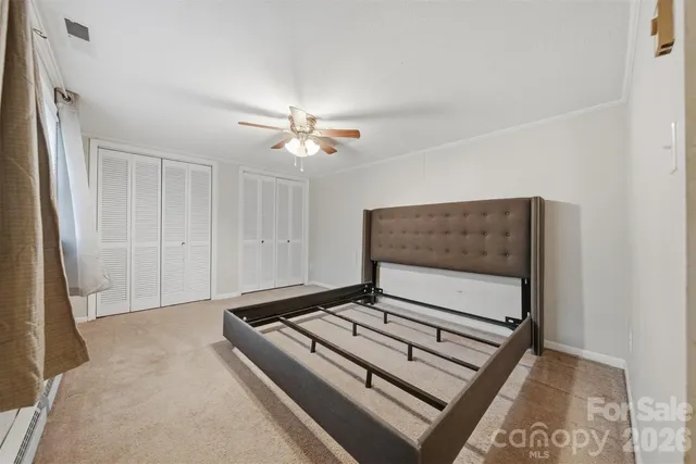 a living room with hard wood floor and white walls