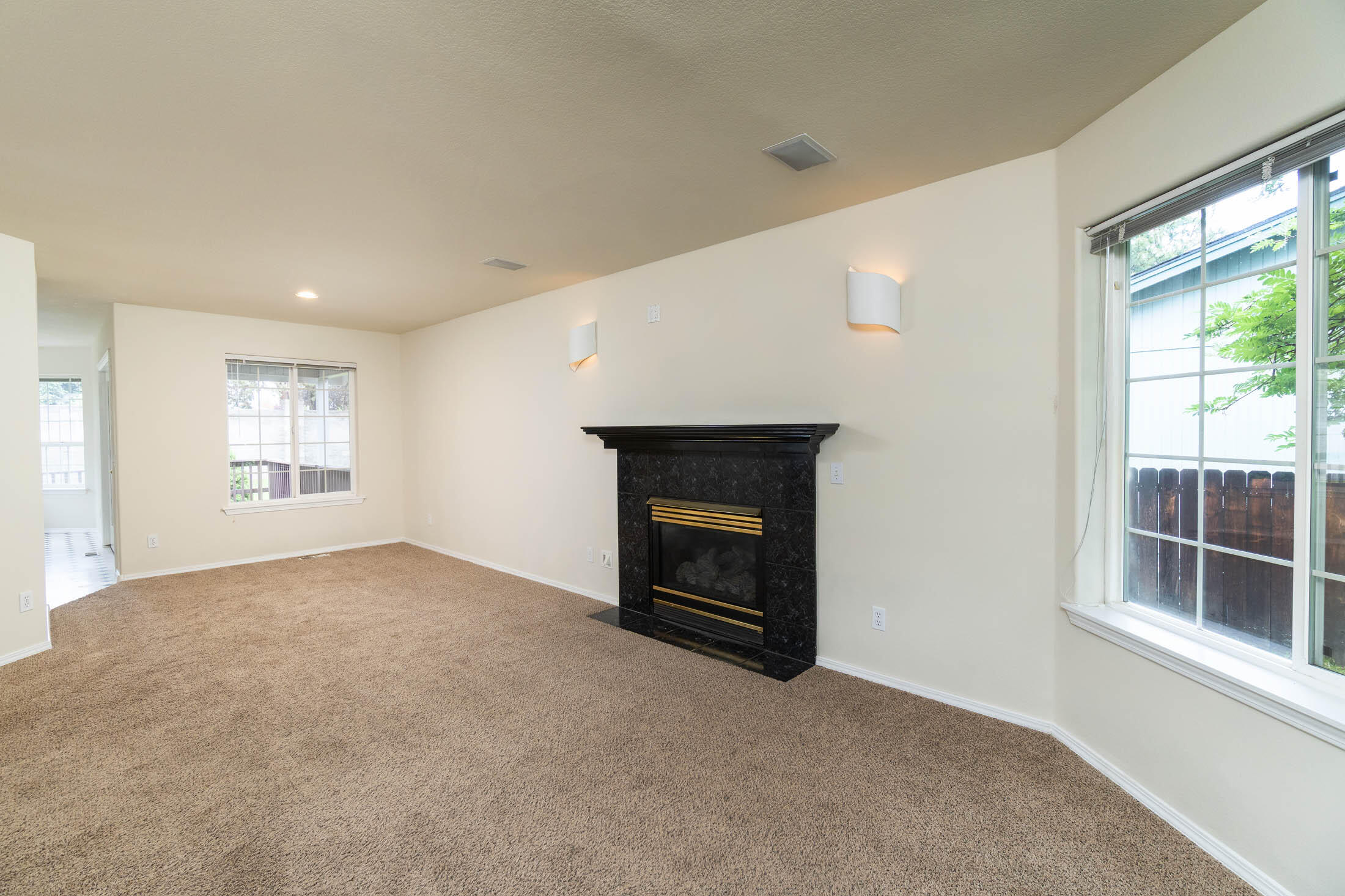 3389 Northeast Stonebrook Loop Bend, OR 97701 - Photo 5 of 27 Nice wall sconces on both sides of the living room fireplace.