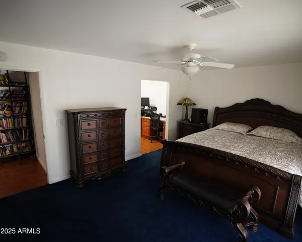 a bedroom with a bed and a chandelier