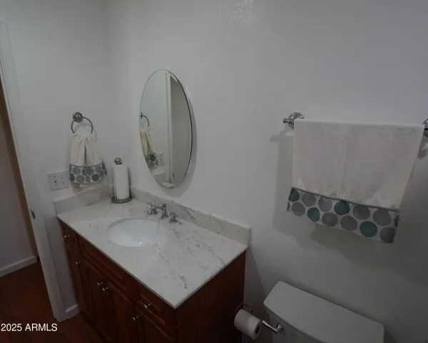 a bathroom with a sink toilet and a mirror