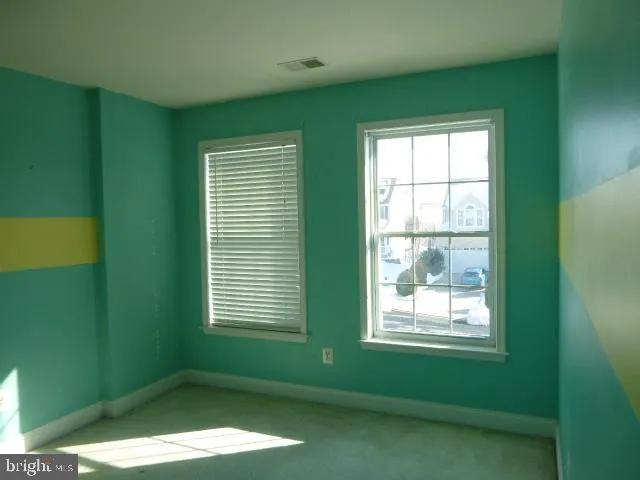 a bathroom with a window and a shower