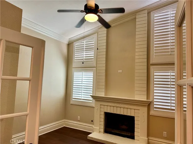 a view of a livingroom with a fireplace and window