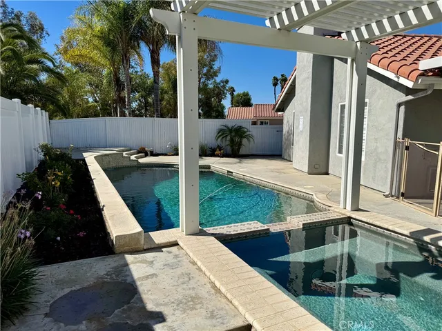 a view of a house with backyard and sitting area
