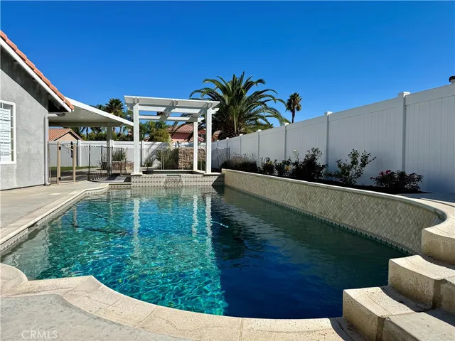 a backyard of a house with table and chairs