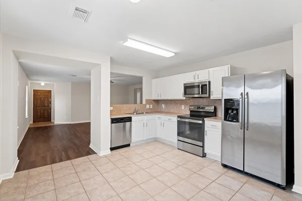 a kitchen with a refrigerator sink and microwave