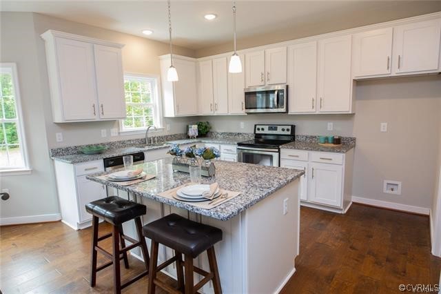 Lot 10 Corte Castle Road Chesterfield, VA 23838 - Photo 8 of 37 a kitchen with stainless steel appliances granite countertop a stove top oven a sink a refrigerator and white cabinets with wooden floor