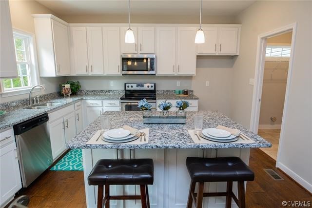 Lot 10 Corte Castle Road Chesterfield, VA 23838 - Photo 9 of 37 a kitchen with stainless steel appliances a white table and chairs in it
