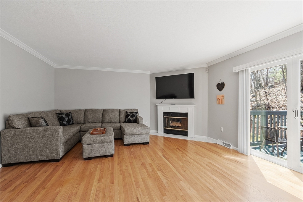 13 Boulderbrook Drive, Unit 13 Peabody, MA 01960 - Photo 11 of 41 a living room with furniture and a flat screen tv