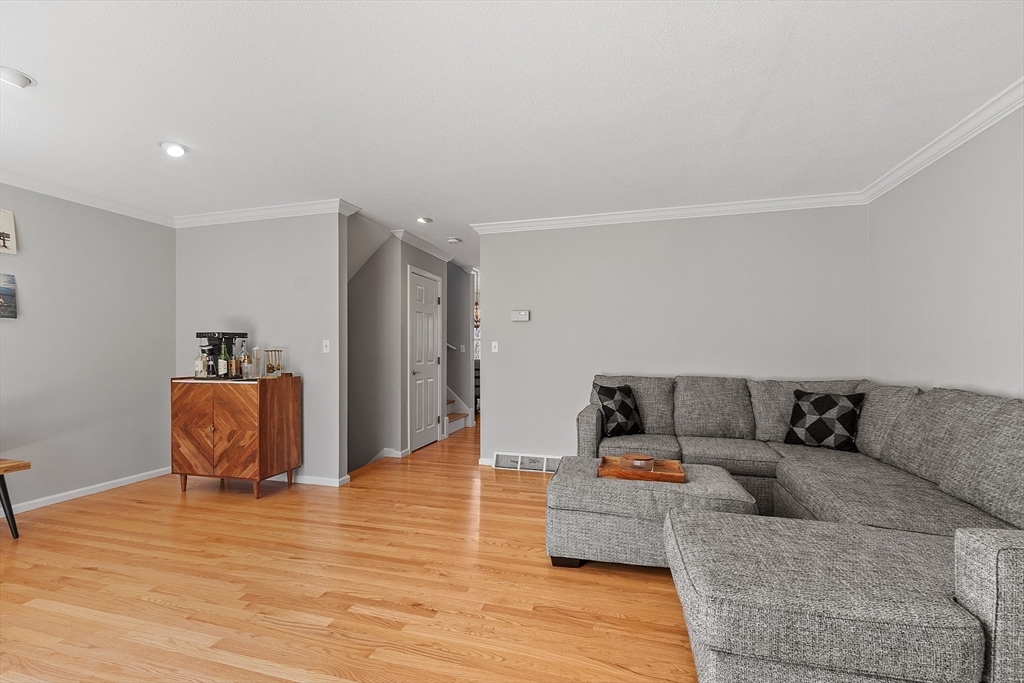 13 Boulderbrook Drive, Unit 13 Peabody, MA 01960 - Photo 13 of 41 a living room with furniture and a wooden floor