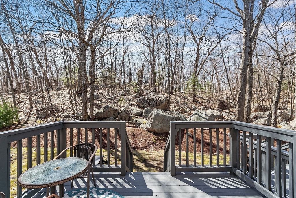 13 Boulderbrook Drive, Unit 13 Peabody, MA 01960 - Photo 14 of 41 a view of a roof deck with table and chairs with wooden floor and fence