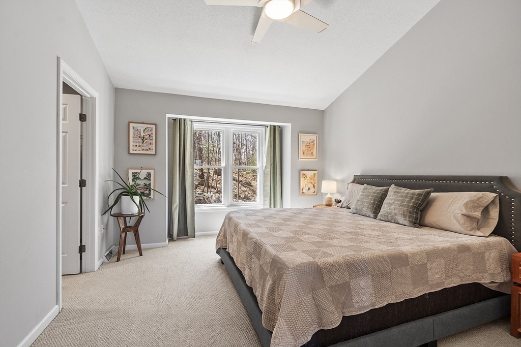 13 Boulderbrook Drive, Unit 13 Peabody, MA 01960 - Photo 18 of 41 a bedroom with a bed and a table