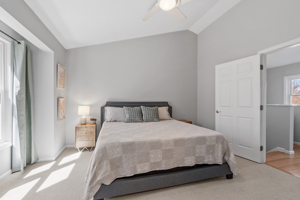 13 Boulderbrook Drive, Unit 13 Peabody, MA 01960 - Photo 19 of 41 a bedroom with a bed and wooden floor