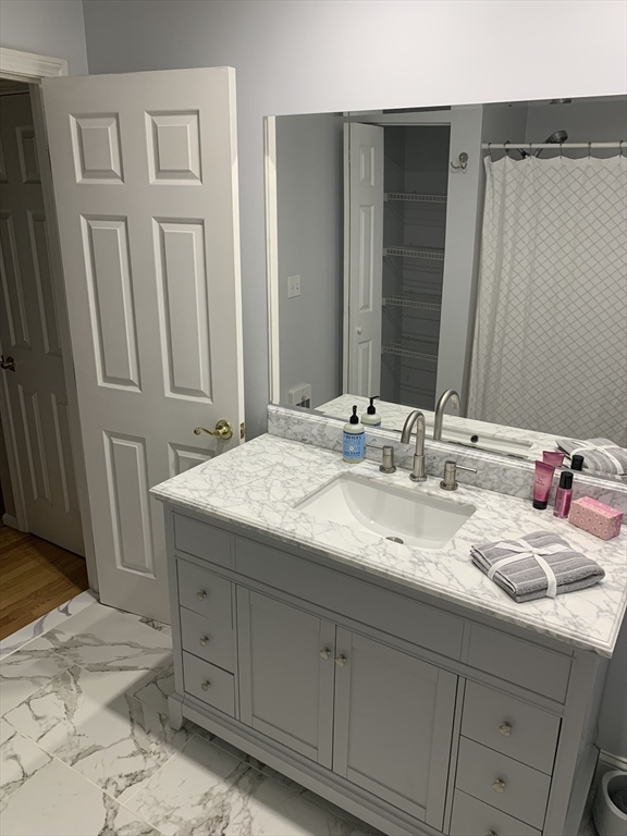 13 Boulderbrook Drive, Unit 13 Peabody, MA 01960 - Photo 23 of 41 a bathroom with a sink and a mirror