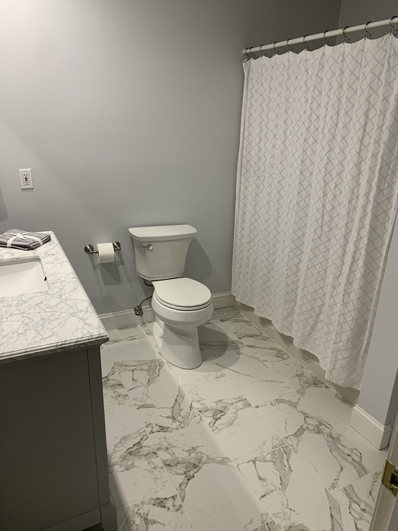 13 Boulderbrook Drive, Unit 13 Peabody, MA 01960 - Photo 24 of 41 a bathroom with a granite countertop toilet and a sink