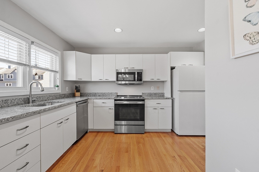 13 Boulderbrook Drive, Unit 13 Peabody, MA 01960 - Photo 5 of 41 a kitchen with stainless steel appliances granite countertop a refrigerator sink and stove