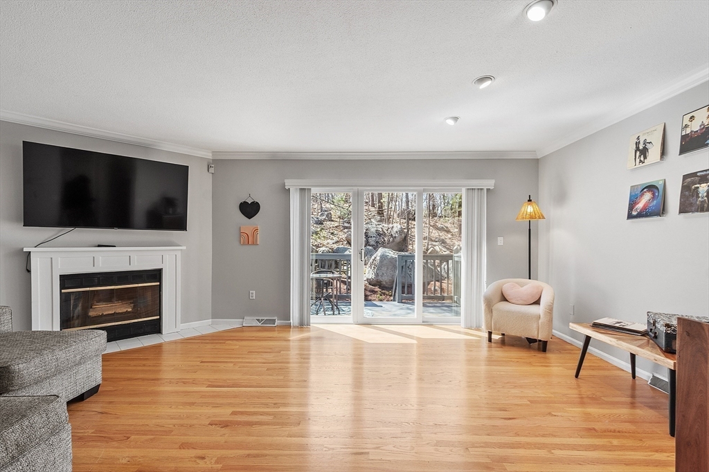 13 Boulderbrook Drive, Unit 13 Peabody, MA 01960 - Photo 10 of 41 a living room with furniture fireplace and flat screen tv