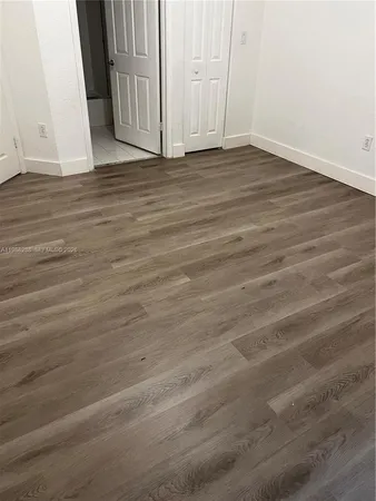 an empty room with wooden floor