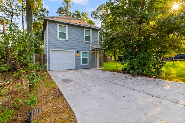 a front view of house along with trees