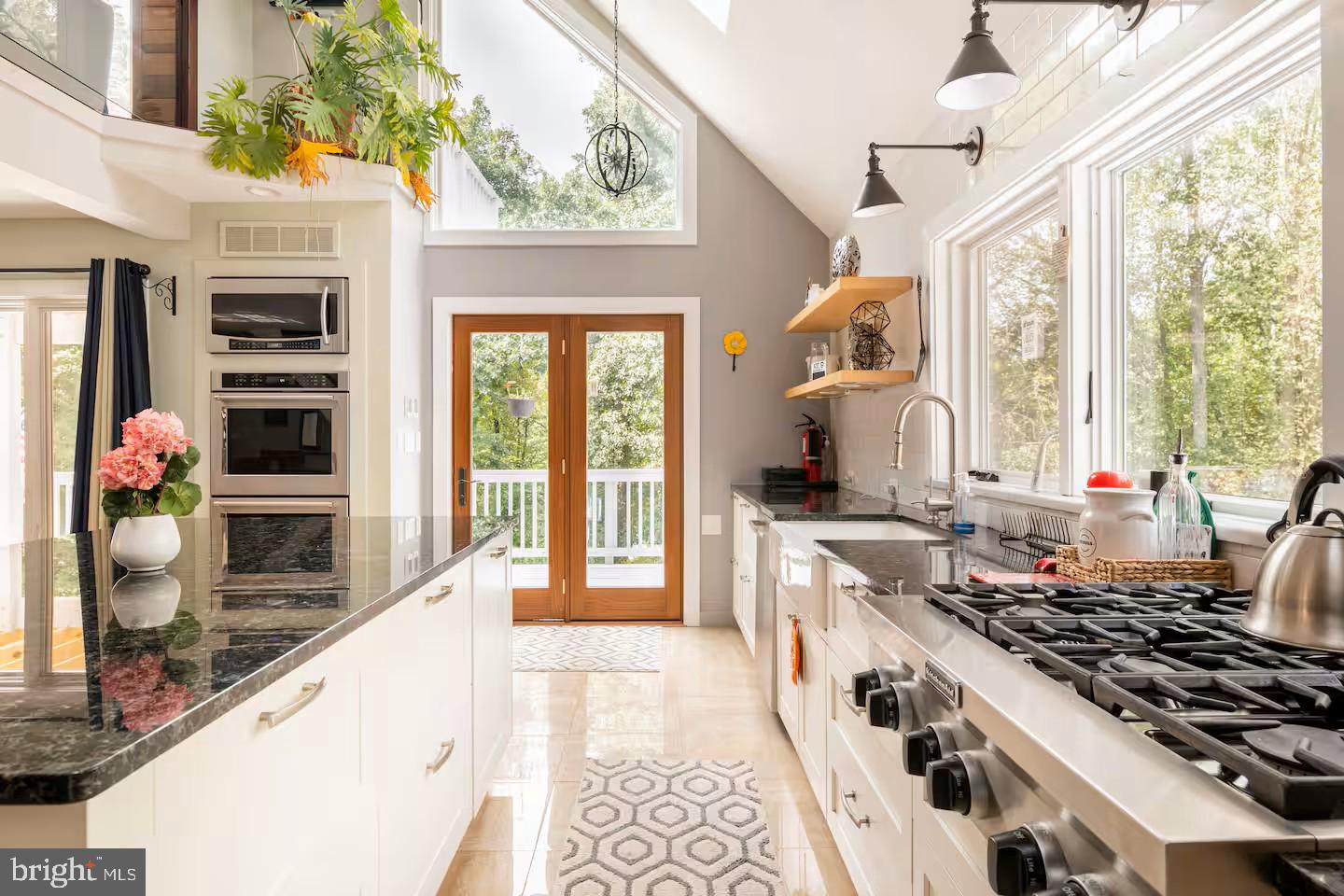 19319 Harmony Church Road Leesburg, VA 20175 - Photo 16 of 65 a kitchen with stainless steel appliances granite countertop a stove and a sink