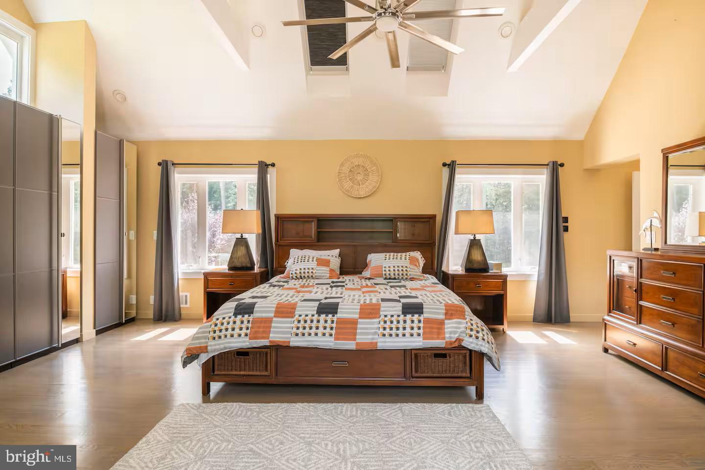 19319 Harmony Church Road Leesburg, VA 20175 - Photo 33 of 65 a bedroom with a large bed and a chandelier