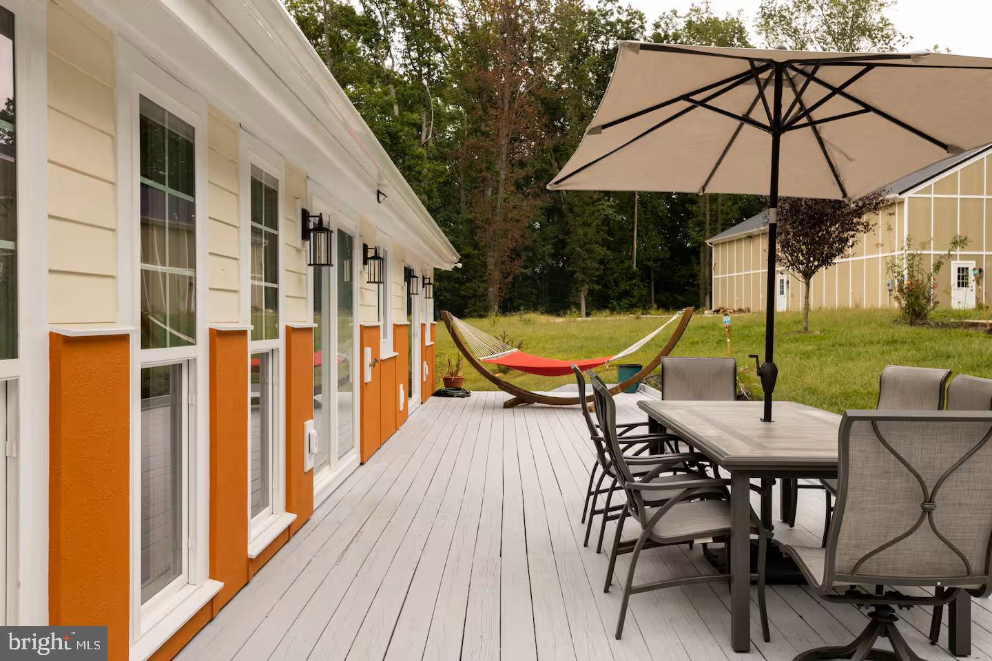 19319 Harmony Church Road Leesburg, VA 20175 - Photo 56 of 65 a view of a patio with a table and chairs under an umbrella