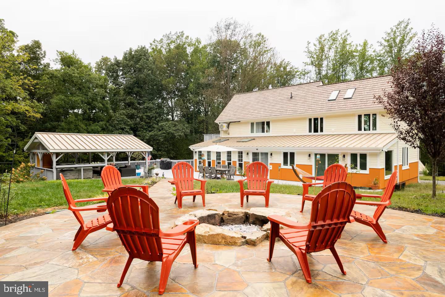 19319 Harmony Church Road Leesburg, VA 20175 - Photo 61 of 65 a view of a patio with a table chairs and a barbeque