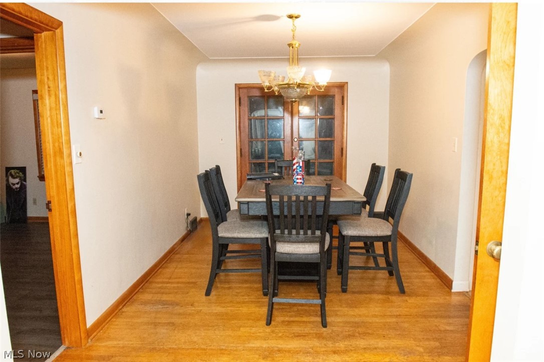 6714 Trenholm Road Youngstown, OH 44512 - Photo 7 of 22 Dining area featuring light wood-type flooring and a chandelier