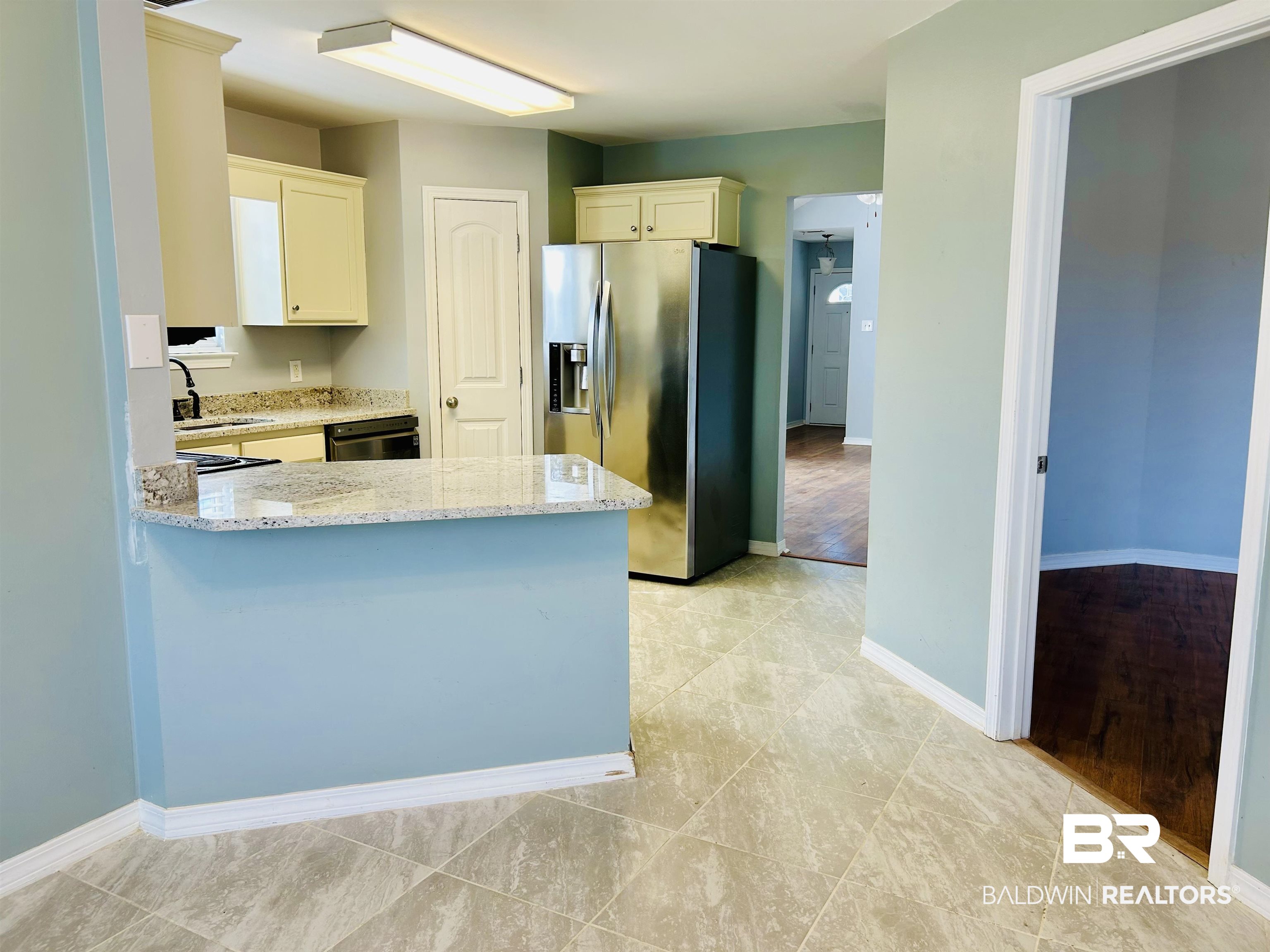 919 Parliament Court Mobile, AL 36695 - Photo 4 of 19 Kitchen with sink, black dishwasher, stainless steel refrigerator with ice dispenser, light stone counters, and white cabinets