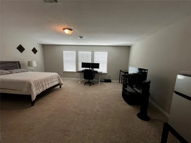 a living room with a bed furniture and a large window