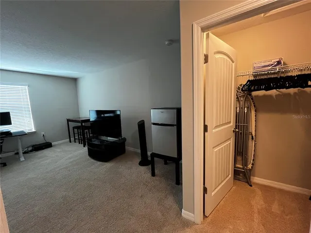 a view of a livingroom with furniture and a window