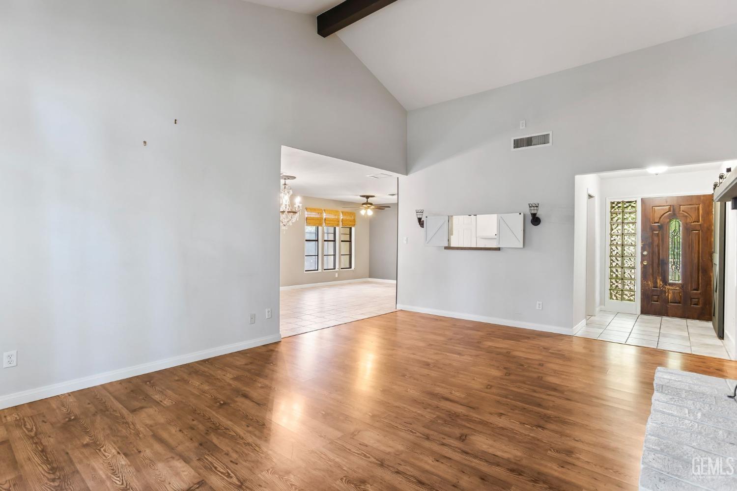 Undisclosed Address Bakersfield, CA 93306 - Photo 12 of 61 an empty room with wooden floor and windows
