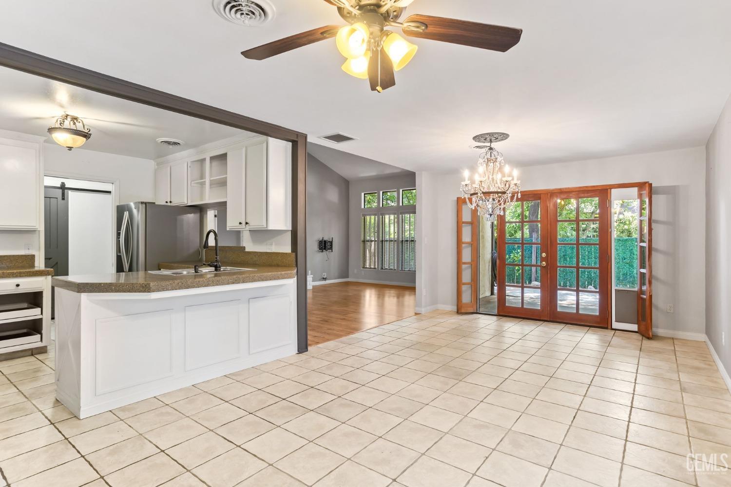 Undisclosed Address Bakersfield, CA 93306 - Photo 14 of 61 a large white kitchen with granite countertop a sink cabinets and stainless steel appliances