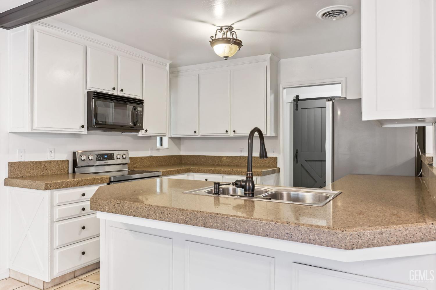 Undisclosed Address Bakersfield, CA 93306 - Photo 17 of 61 a kitchen with granite countertop a sink a stove and refrigerator