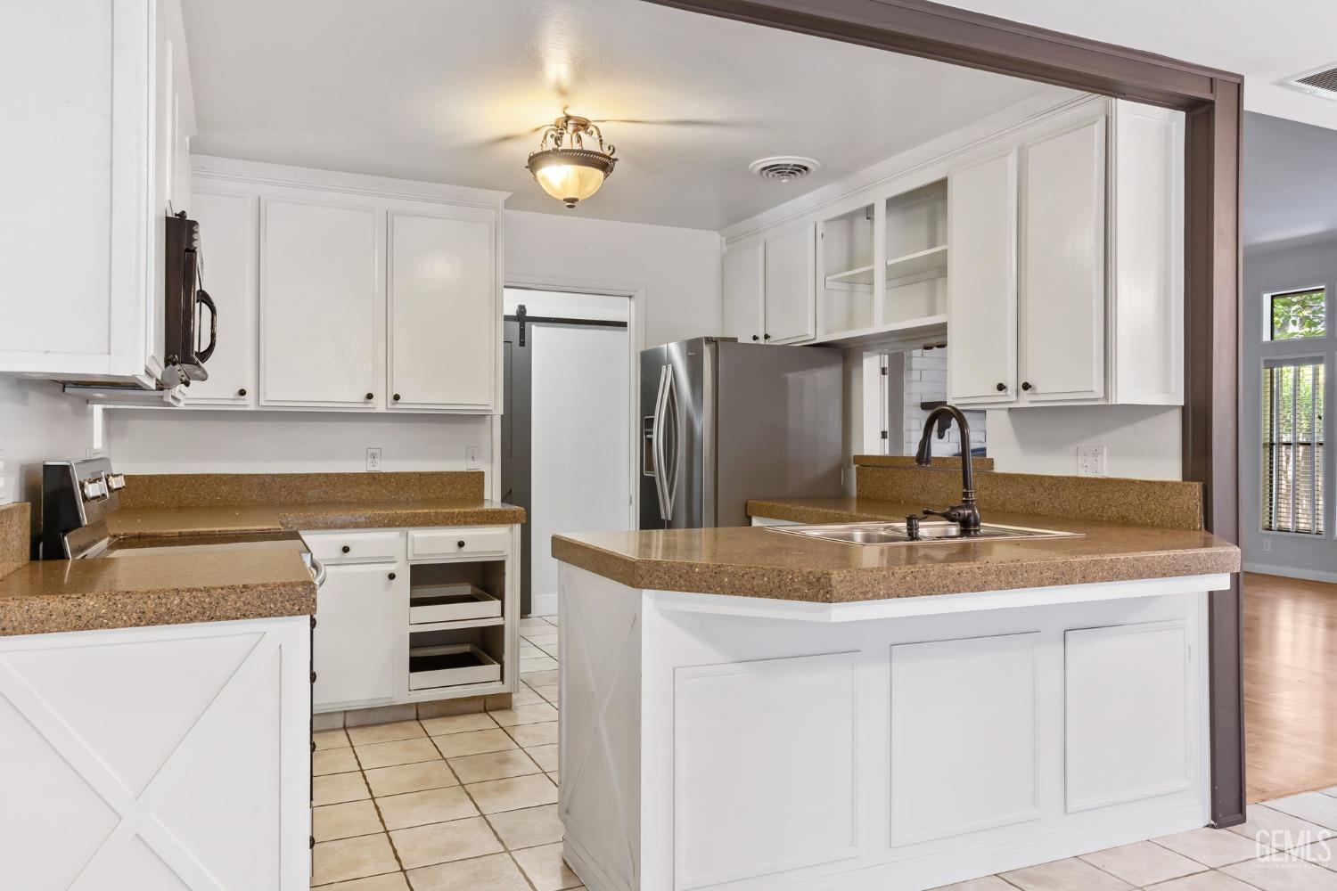 Undisclosed Address Bakersfield, CA 93306 - Photo 19 of 61 a kitchen with stainless steel appliances granite countertop a refrigerator sink and stove