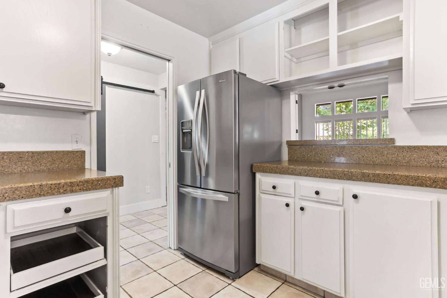 Undisclosed Address Bakersfield, CA 93306 - Photo 20 of 61 a kitchen with granite countertop a refrigerator and a sink