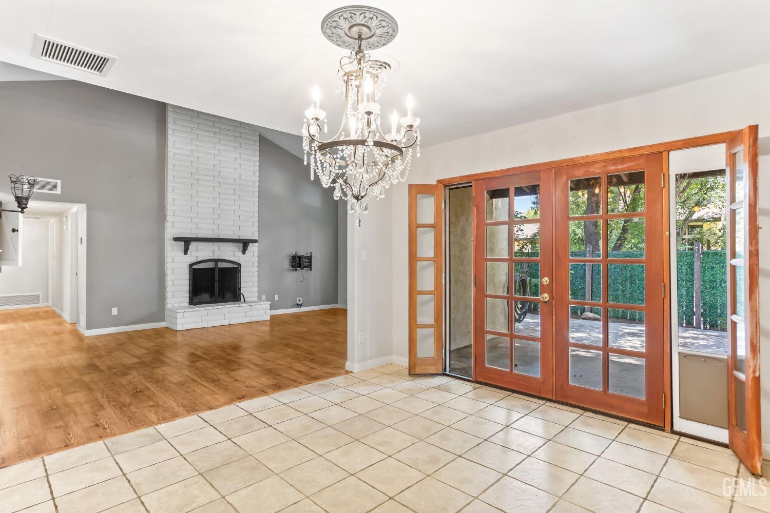 Undisclosed Address Bakersfield, CA 93306 - Photo 26 of 61 a view of a livingroom with a chandelier curtains and large windows