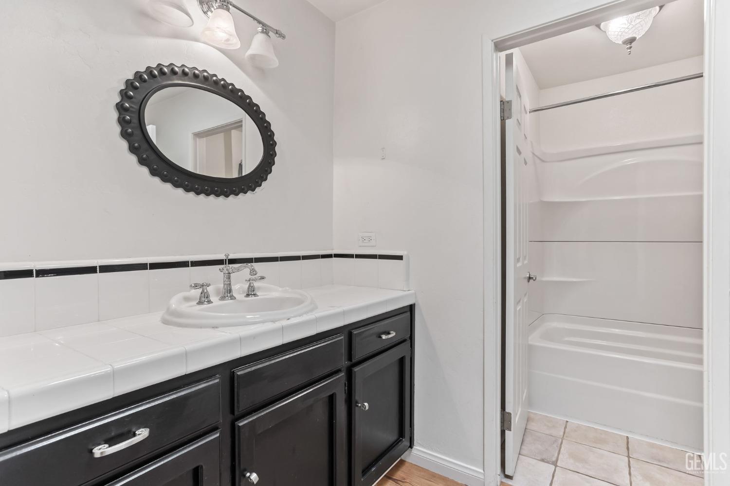 Undisclosed Address Bakersfield, CA 93306 - Photo 29 of 61 a bathroom with a sink and a mirror