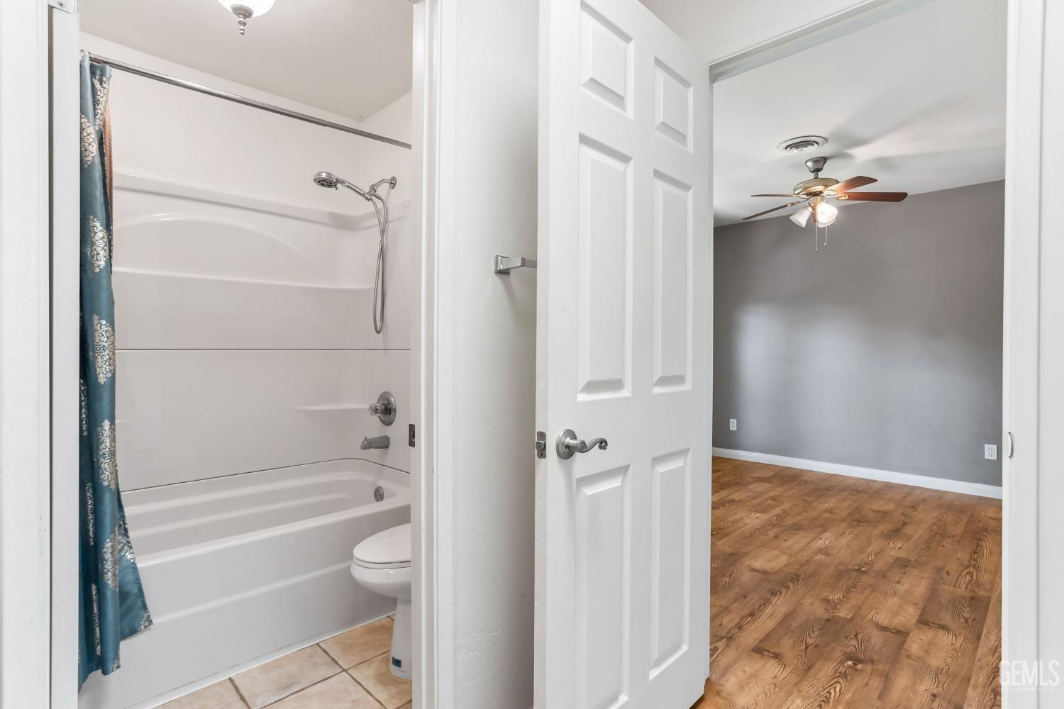 Undisclosed Address Bakersfield, CA 93306 - Photo 30 of 61 a bathroom with a granite countertop shower a toilet and a sink