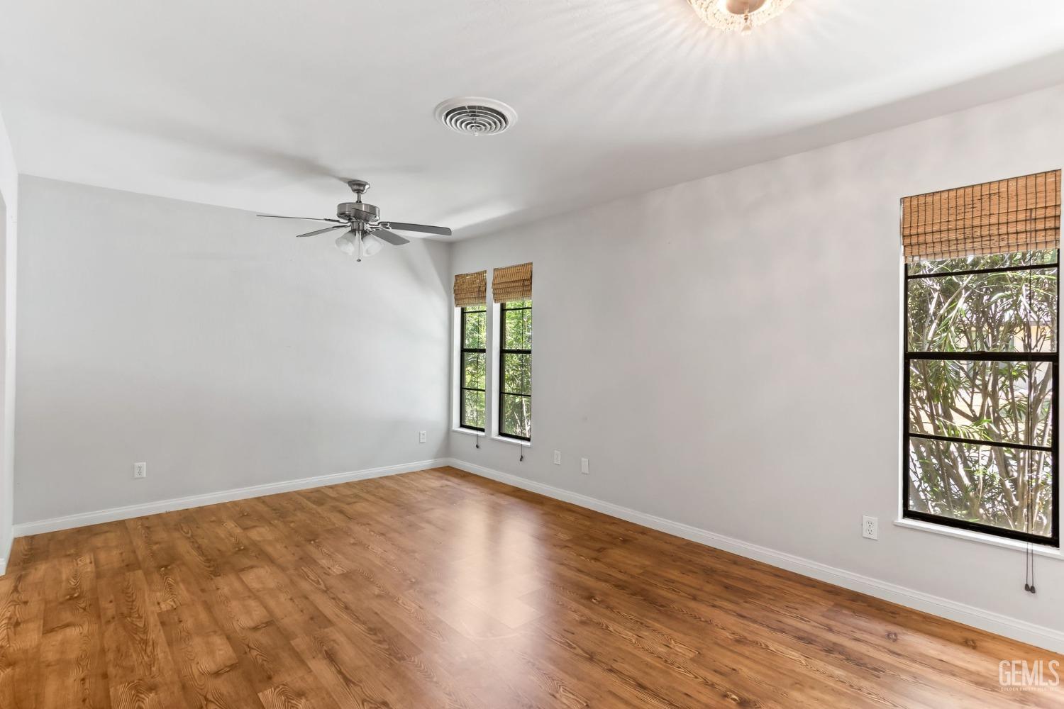 Undisclosed Address Bakersfield, CA 93306 - Photo 33 of 61 a view of an empty room with a window and wooden floor