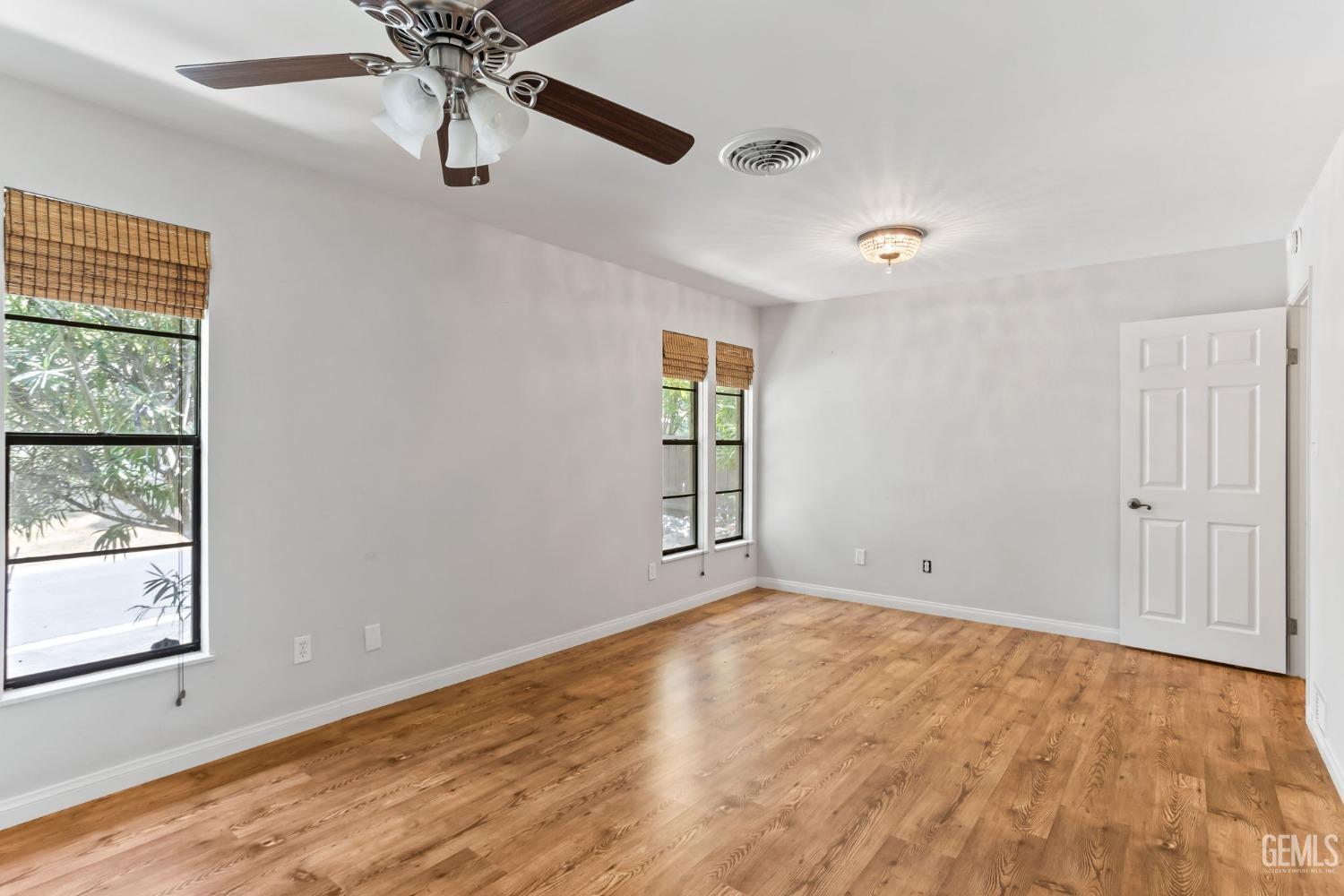 Undisclosed Address Bakersfield, CA 93306 - Photo 34 of 61 wooden floor in an empty room with a window