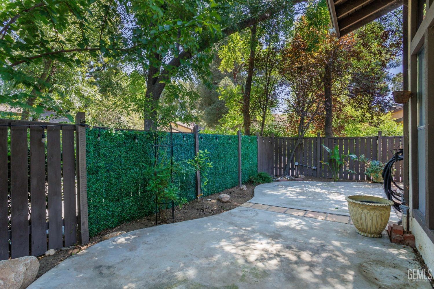 Undisclosed Address Bakersfield, CA 93306 - Photo 41 of 61 a view of a backyard with wooden fence and a bench
