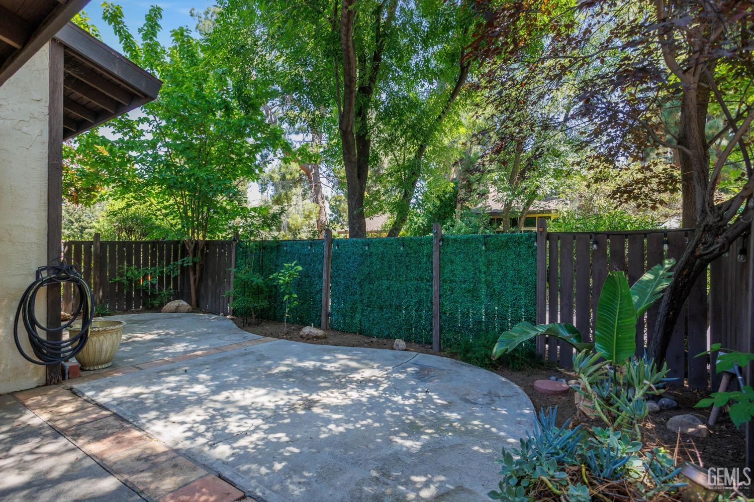 Undisclosed Address Bakersfield, CA 93306 - Photo 43 of 61 a view of a small backyard with wooden fence and a bench
