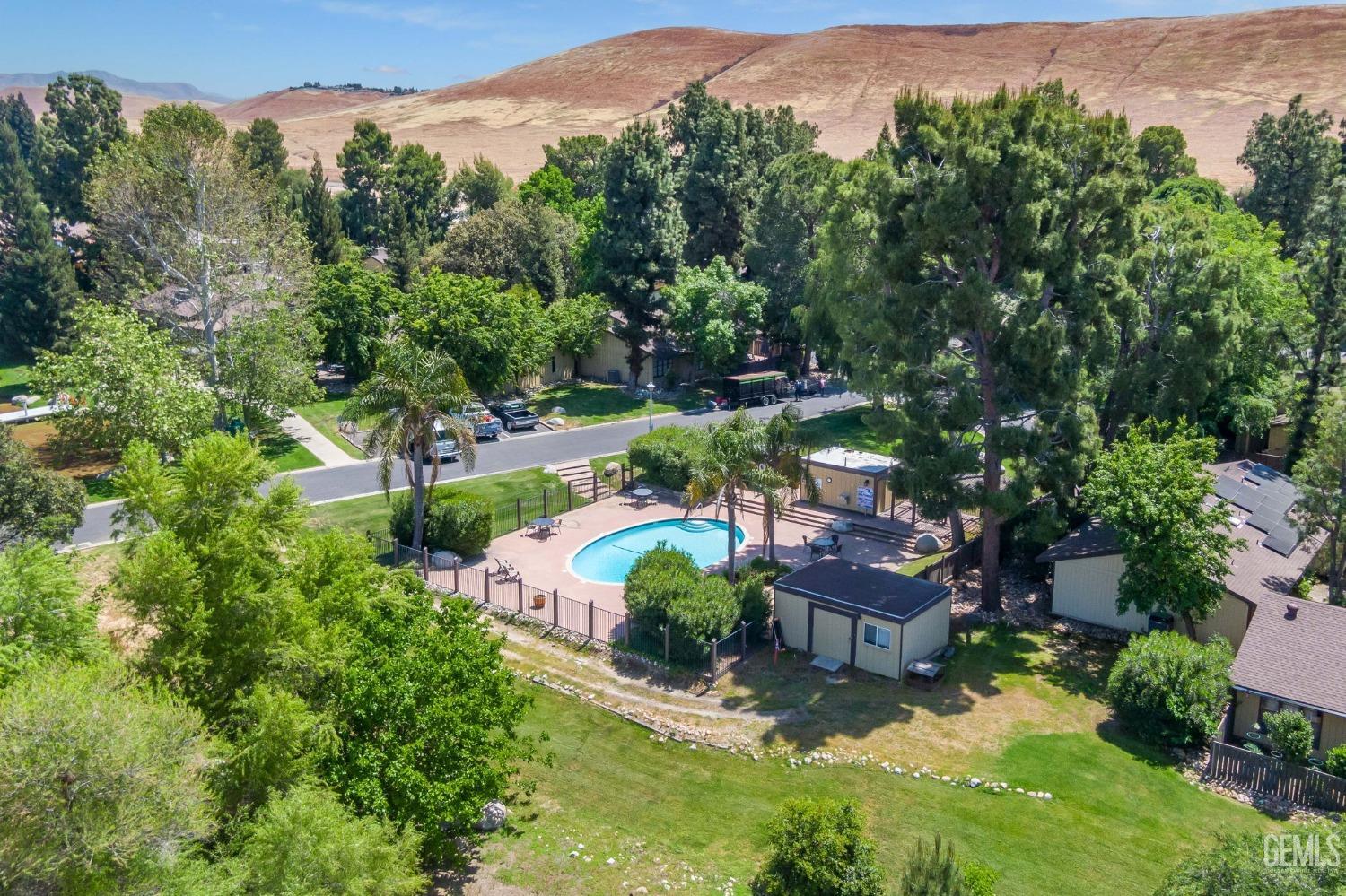 Undisclosed Address Bakersfield, CA 93306 - Photo 50 of 61 an aerial view of a house with yard swimming pool and mountain view in back